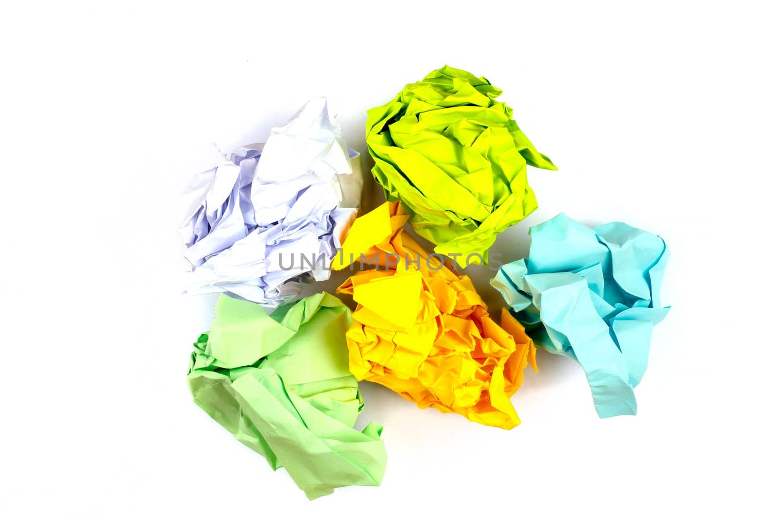 Crumpled and torn color paper isolated on white