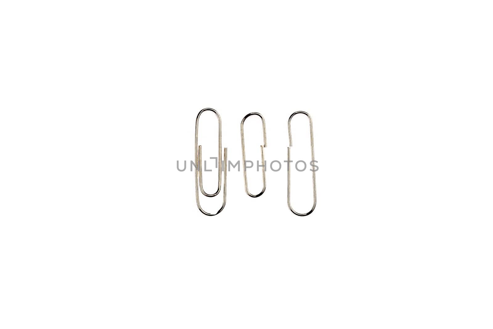 metal paper clip attached to paper isolated on white background. Shiny metal paper clip, page holder, binder.