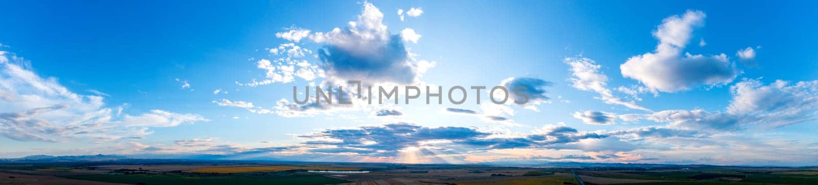 Beautiful clouds and sunlight in the sky at sunset over the land