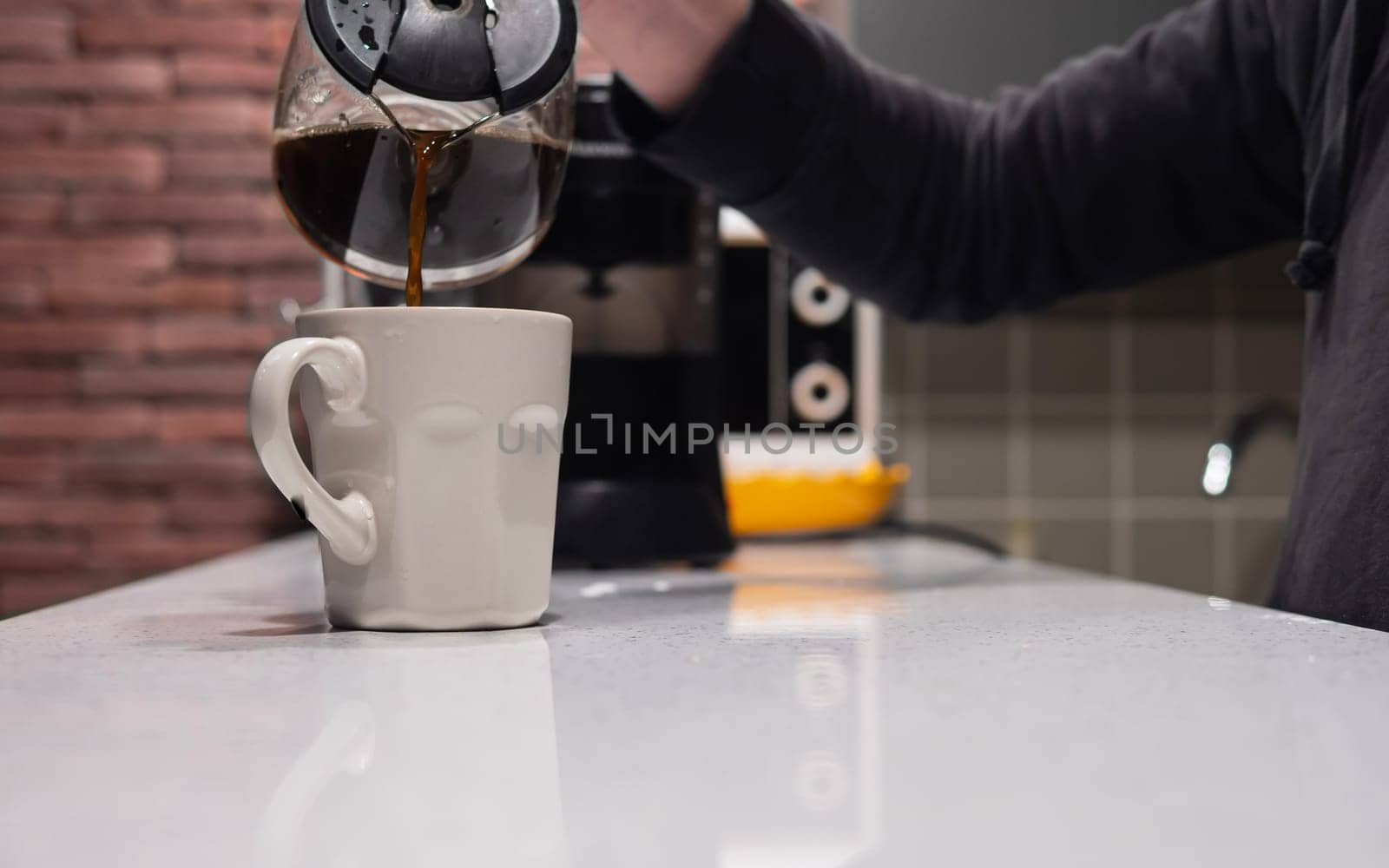 Man pouring coffee into cup at home, closeup. by jackreznor