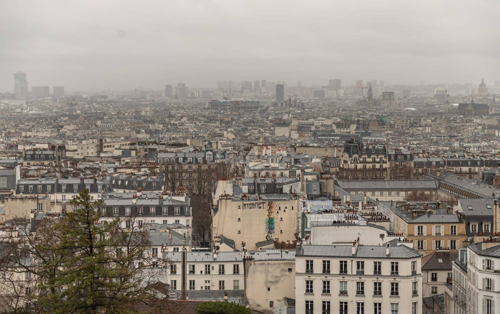 France, Paris - Jan 02, 2024 - Paris city view and rooftops of house From The Top Of Montmartre. Paris Buildings. Space for text, Selective focus.