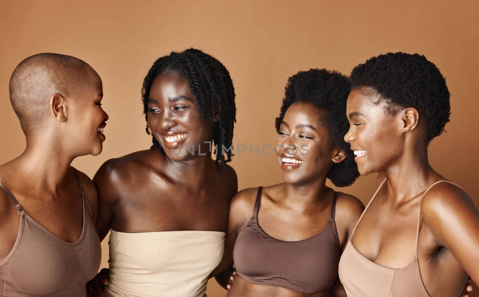 Face, skincare and laughing with black woman friends in studio on a brown background for natural wellness. Portrait, beauty and smile with a group of funny people looking happy at antiaging treatment.