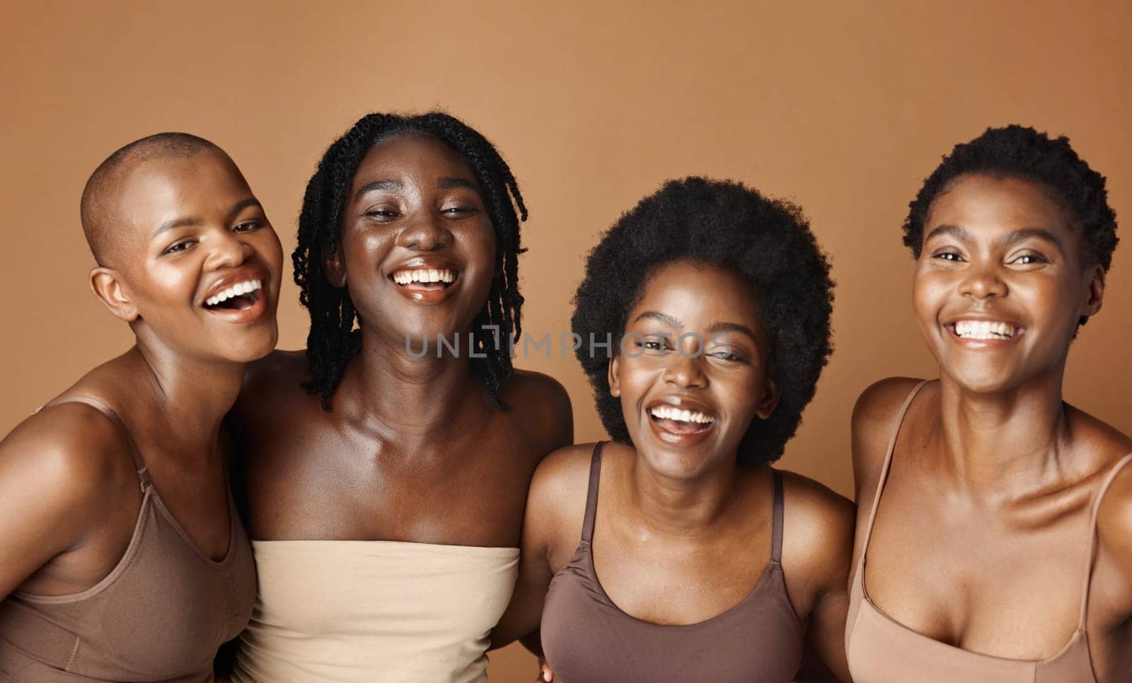 Face, skincare and laughing with black woman friends in studio on a brown background for natural wellness. Portrait, beauty and smile with a group of funny people looking happy at antiaging treatment.