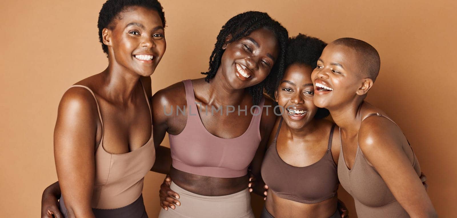 Laughing, face or happy black women with beauty, glowing skin or pride isolated on brown background. Facial dermatology, friends hug or natural skincare in studio with funny models or African people.
