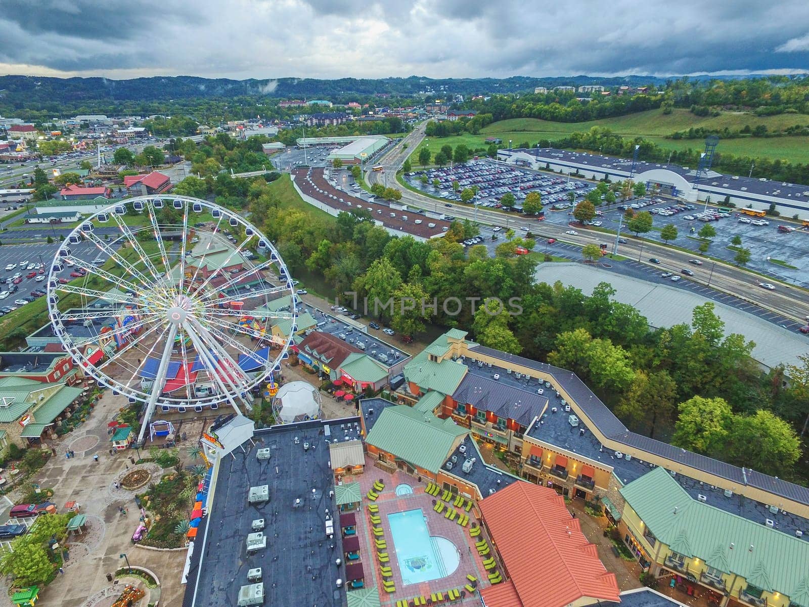 Aerial view of vibrant entertainment complex with Ferris wheel in Pidgeon Forge, Tennessee, late afternoon ambiance with impending weather