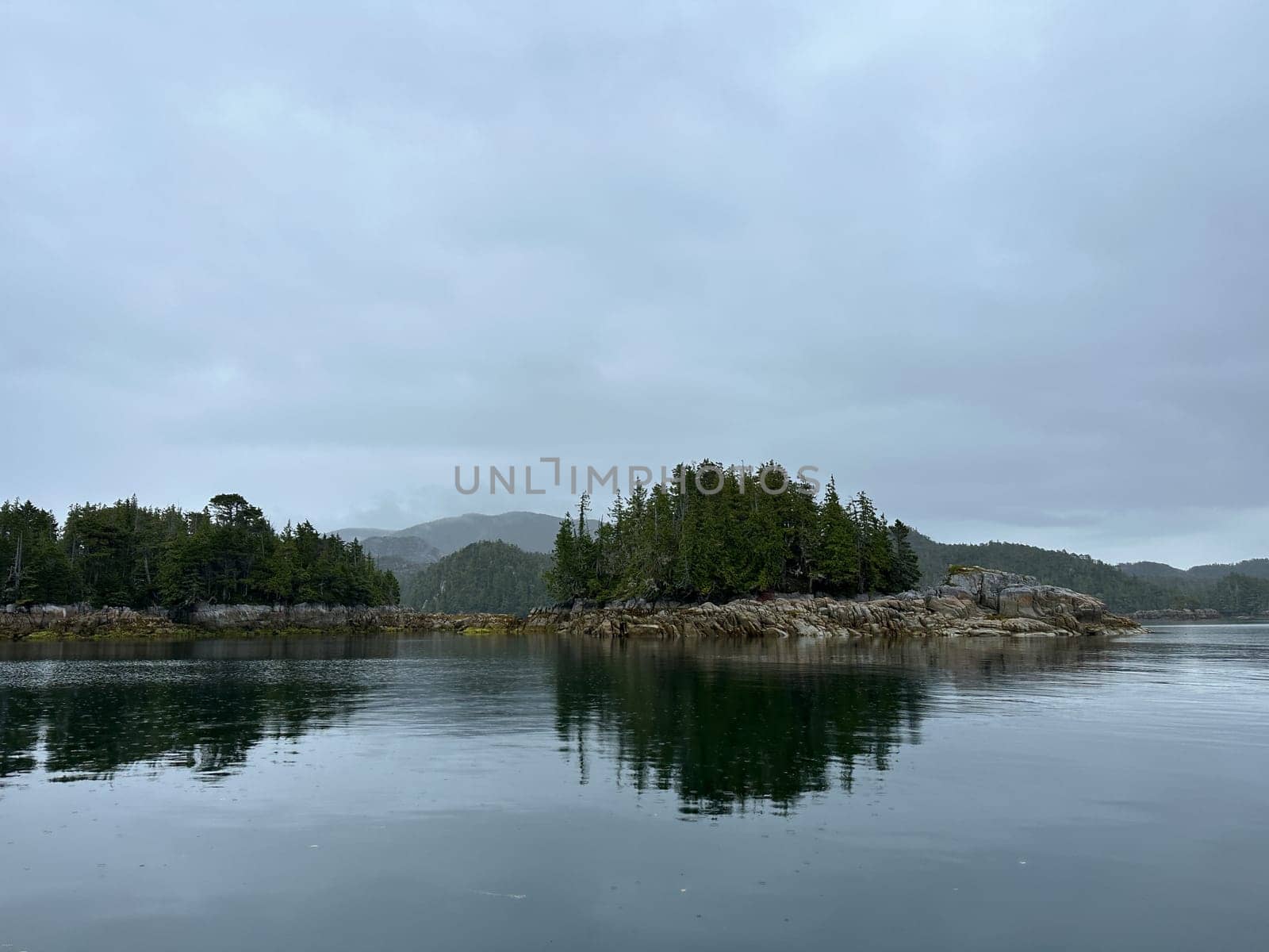 Scenic view of several islands along the Central Coast of British Columbia on an overcast and moody day. Near Stryker Island, British Columbia, Canada