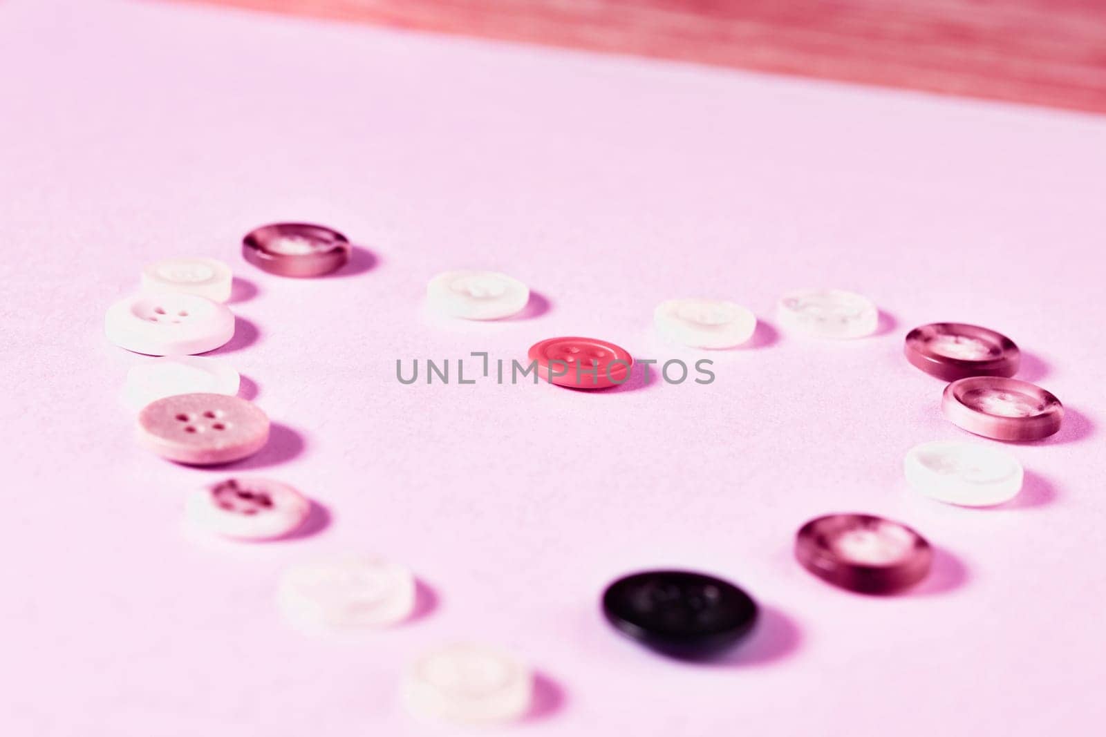 Colored buttons forming heart shape on colored background , passion and love ,Valentine's day