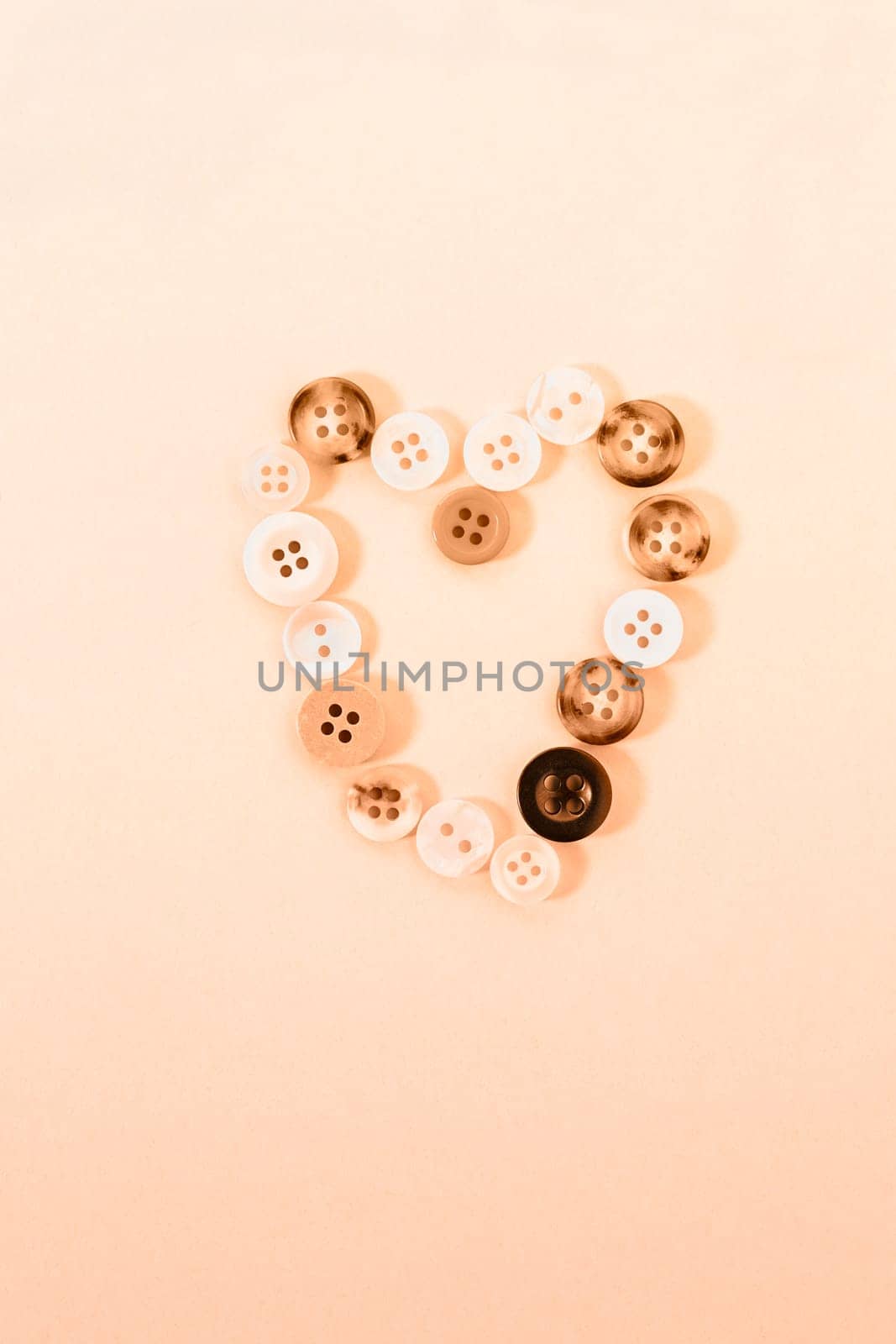  Buttons forming heart shape on peach colored background , passion and love ,Valentine's day