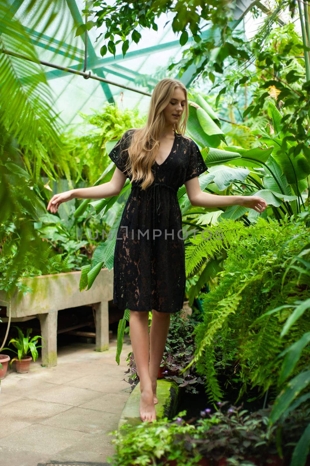 Beautiful young woman wearing summer clothes on tropical resort by OleksandrLipko