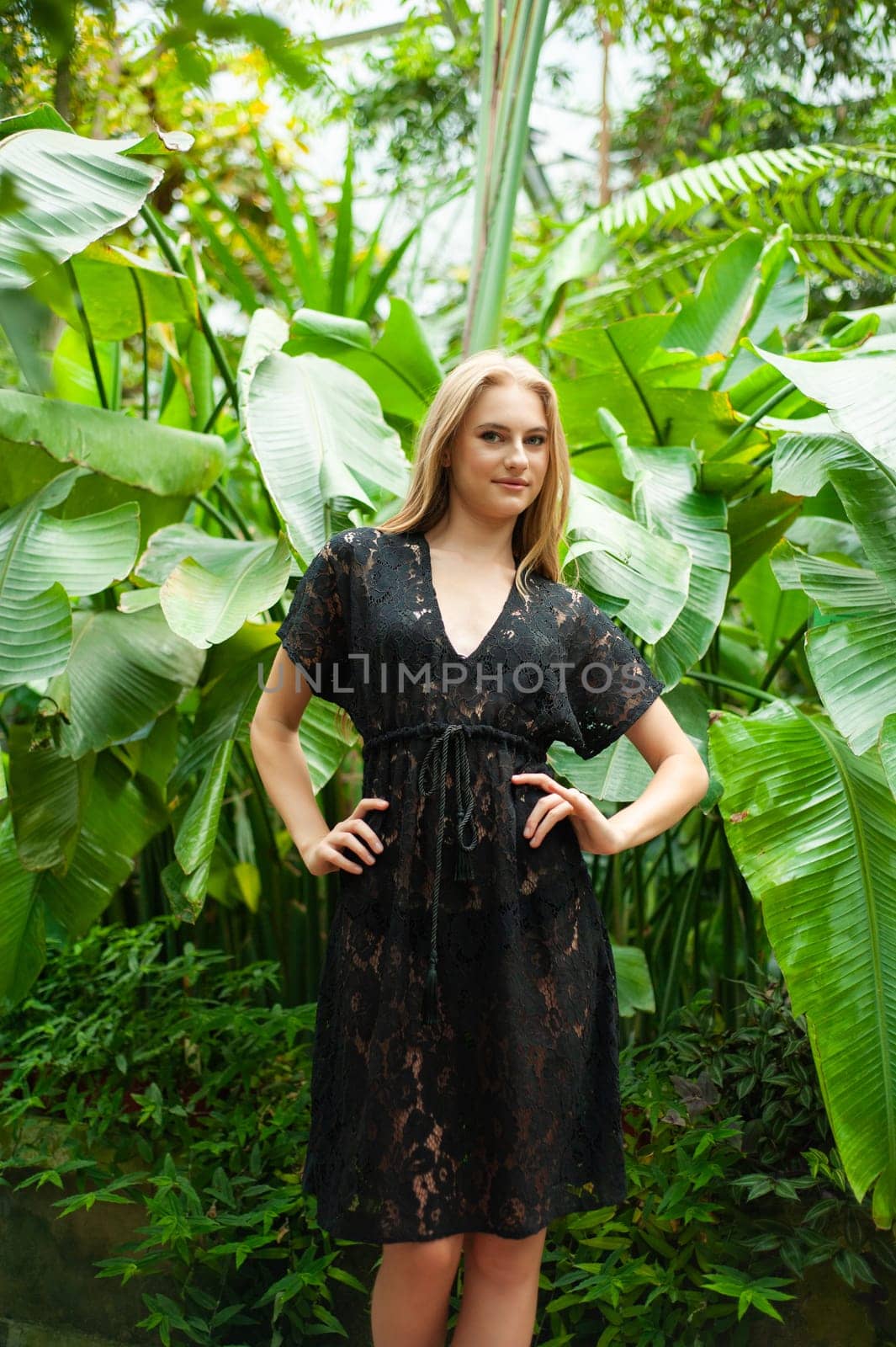 Beautiful young woman wearing summer clothes on tropical resort by OleksandrLipko