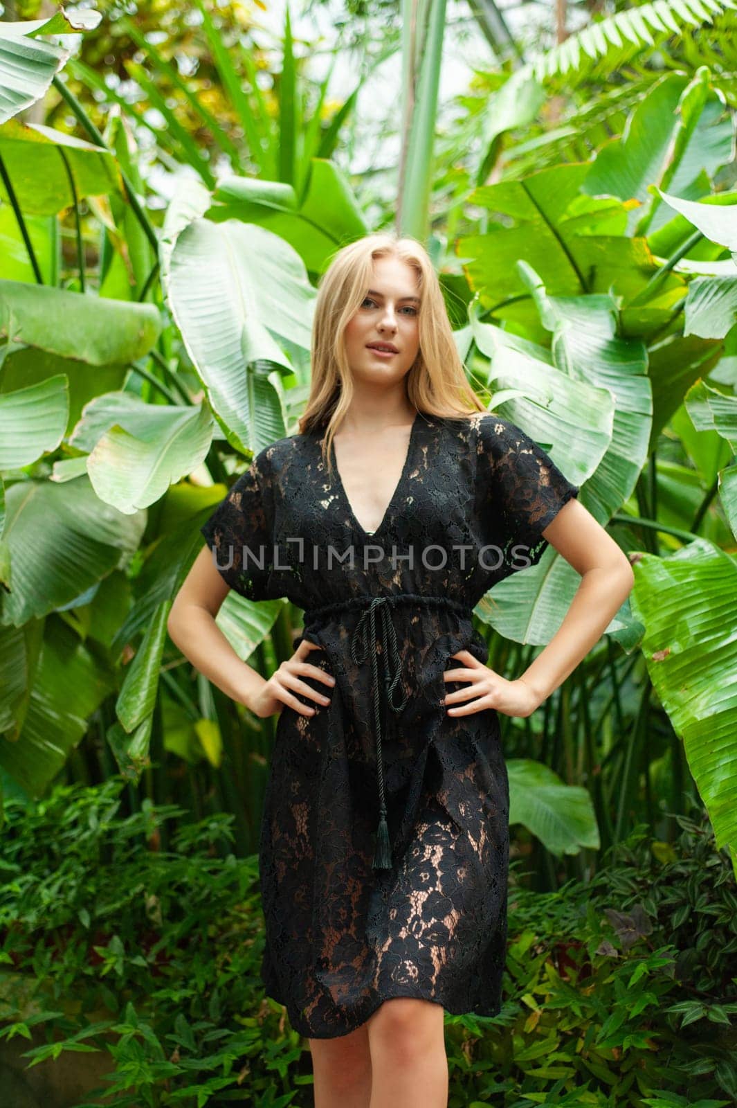 Beautiful young woman wearing summer clothes on tropical resort by OleksandrLipko