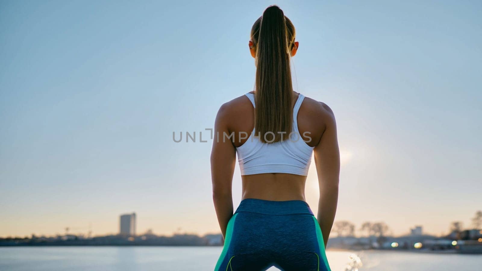 sport woman with the sea and blurred city for her eyes. Sportgirl looking at futuristic blured city, Sport happy new year 2024 cover concept. High quality image