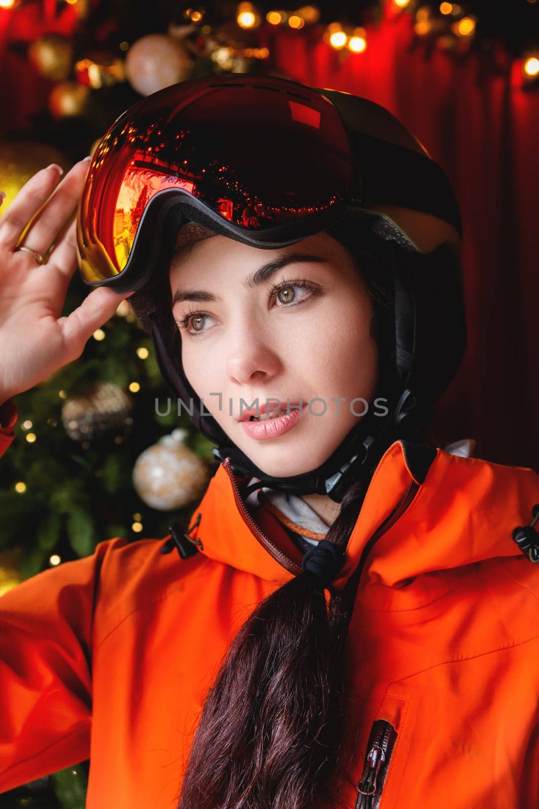 Portrait of a woman in the Alps. Young beautiful caucasian woman in ski goggles looking at the camera with a sexy look.