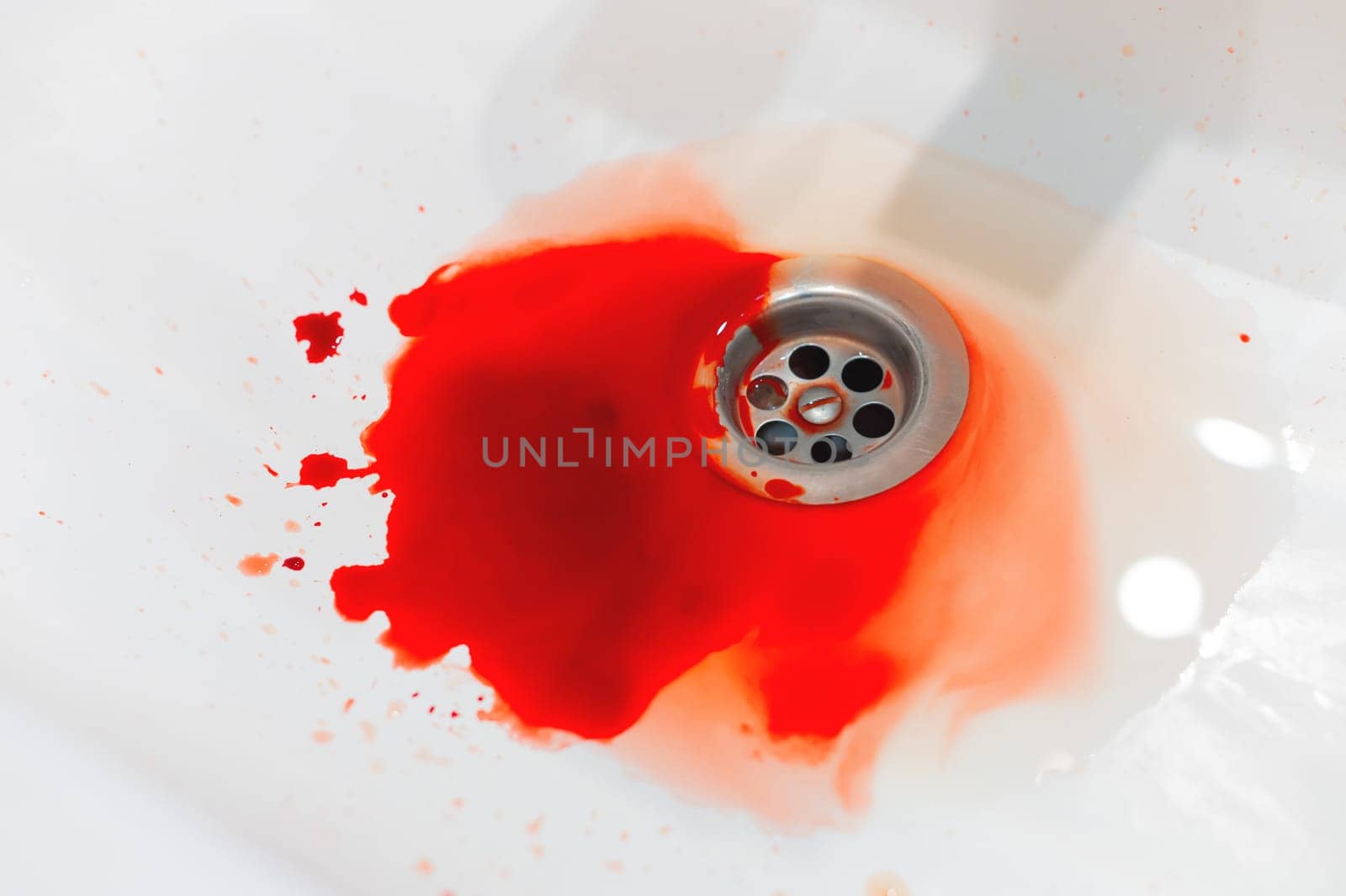 Blood in a white ceramic sink. Bleeding gums or wound of a person. Close-up of an abundance of blood in the bathroom by yanik88