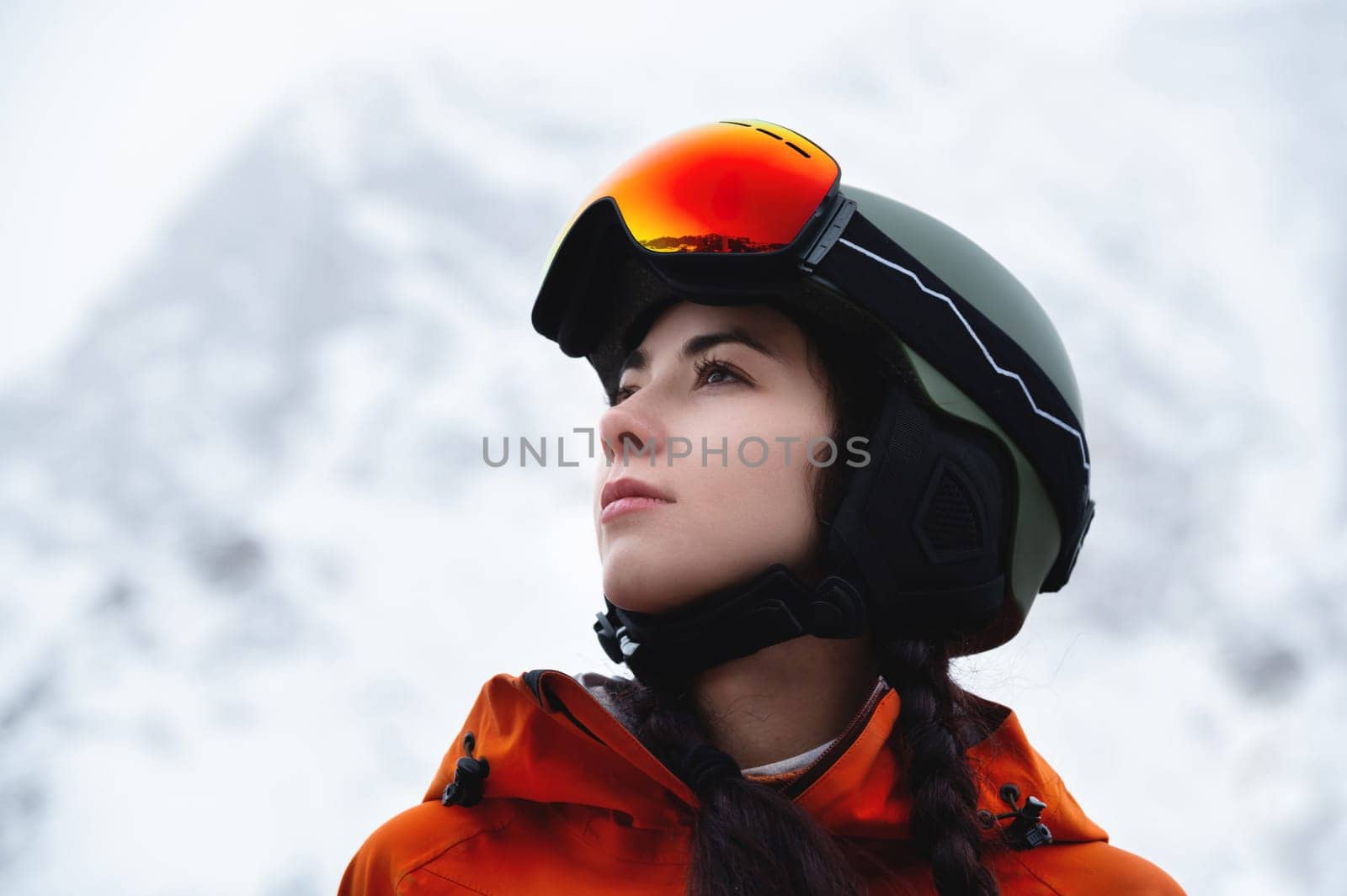 Portrait of a woman in the Alps. Young beautiful caucasian woman in ski goggles looking at the camera with a sexy look by yanik88