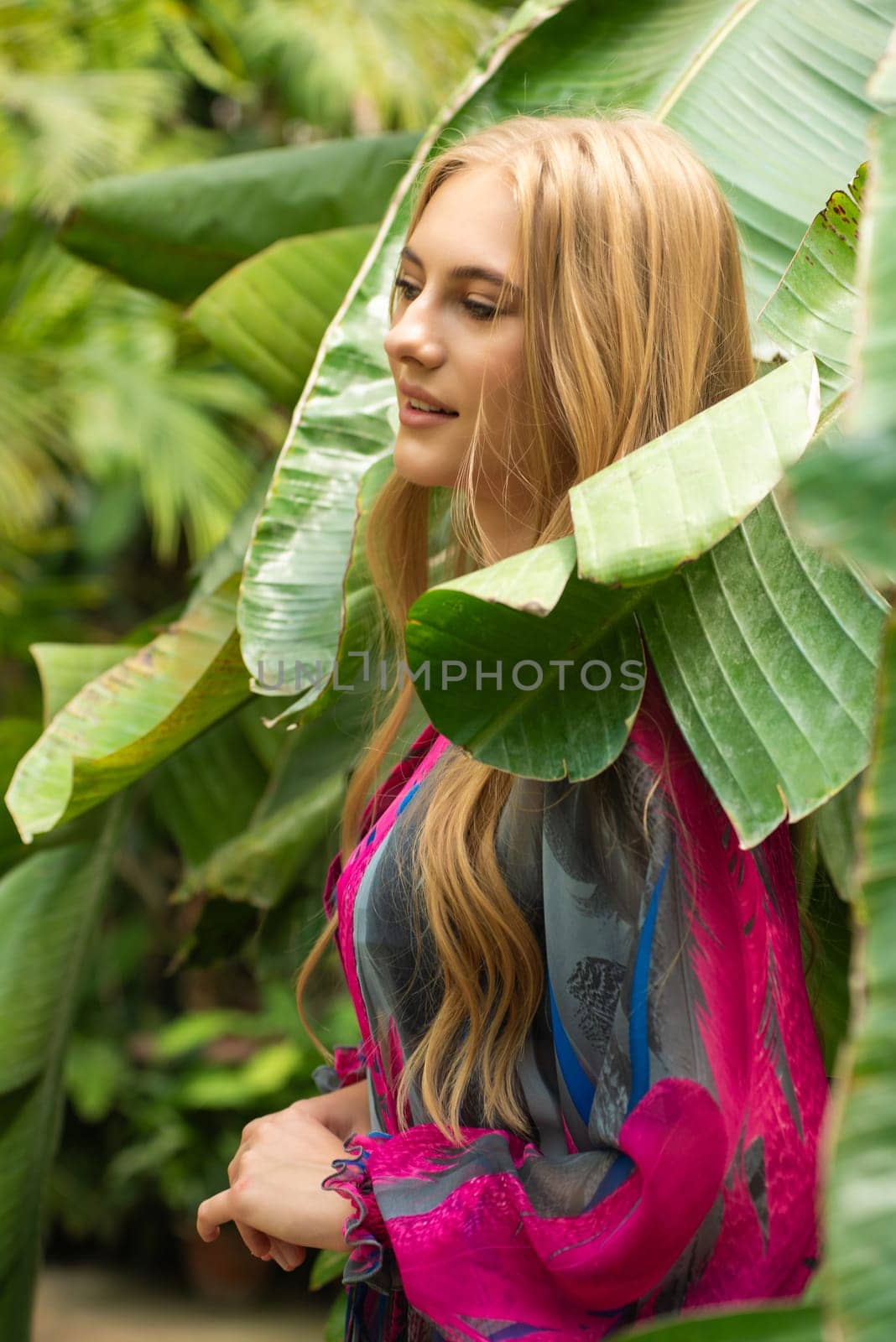 Beautiful young woman wearing summer clothes on tropical resort by OleksandrLipko