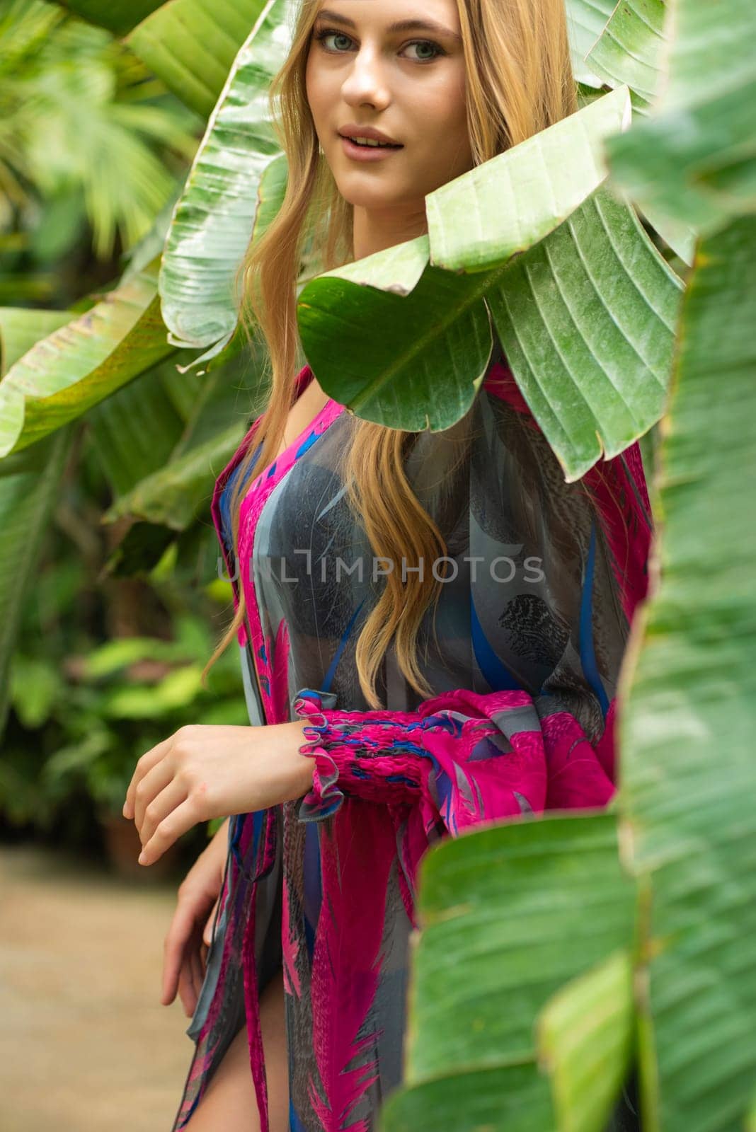 Beautiful young woman wearing summer clothes on tropical resort by OleksandrLipko