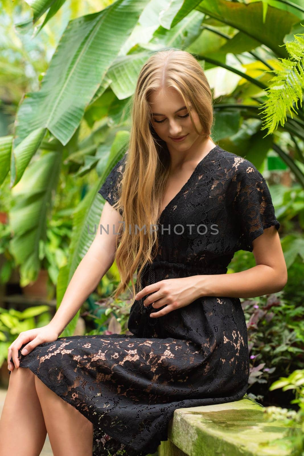 Beautiful young woman wearing summer clothes on tropical resort by OleksandrLipko