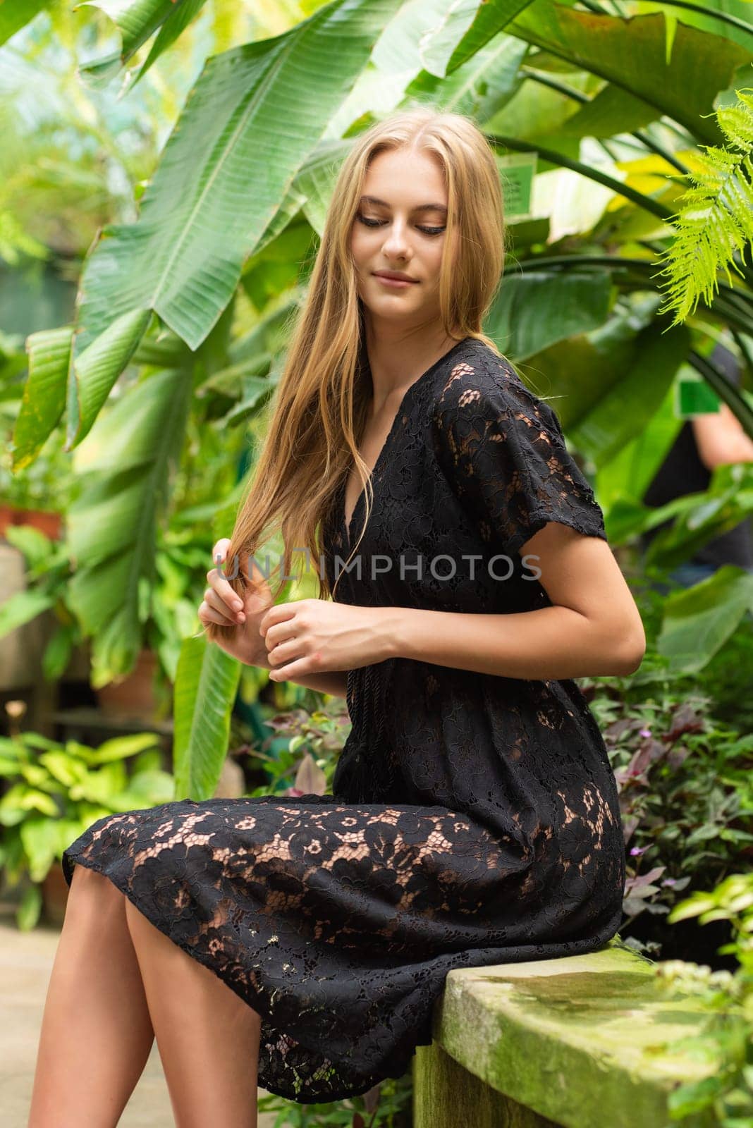 Beautiful young woman wearing summer clothes on tropical resort by OleksandrLipko