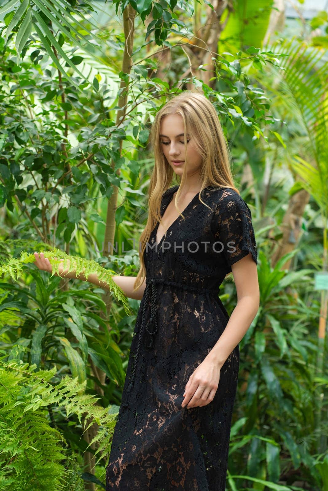 Beautiful young woman wearing summer clothes on tropical resort by OleksandrLipko