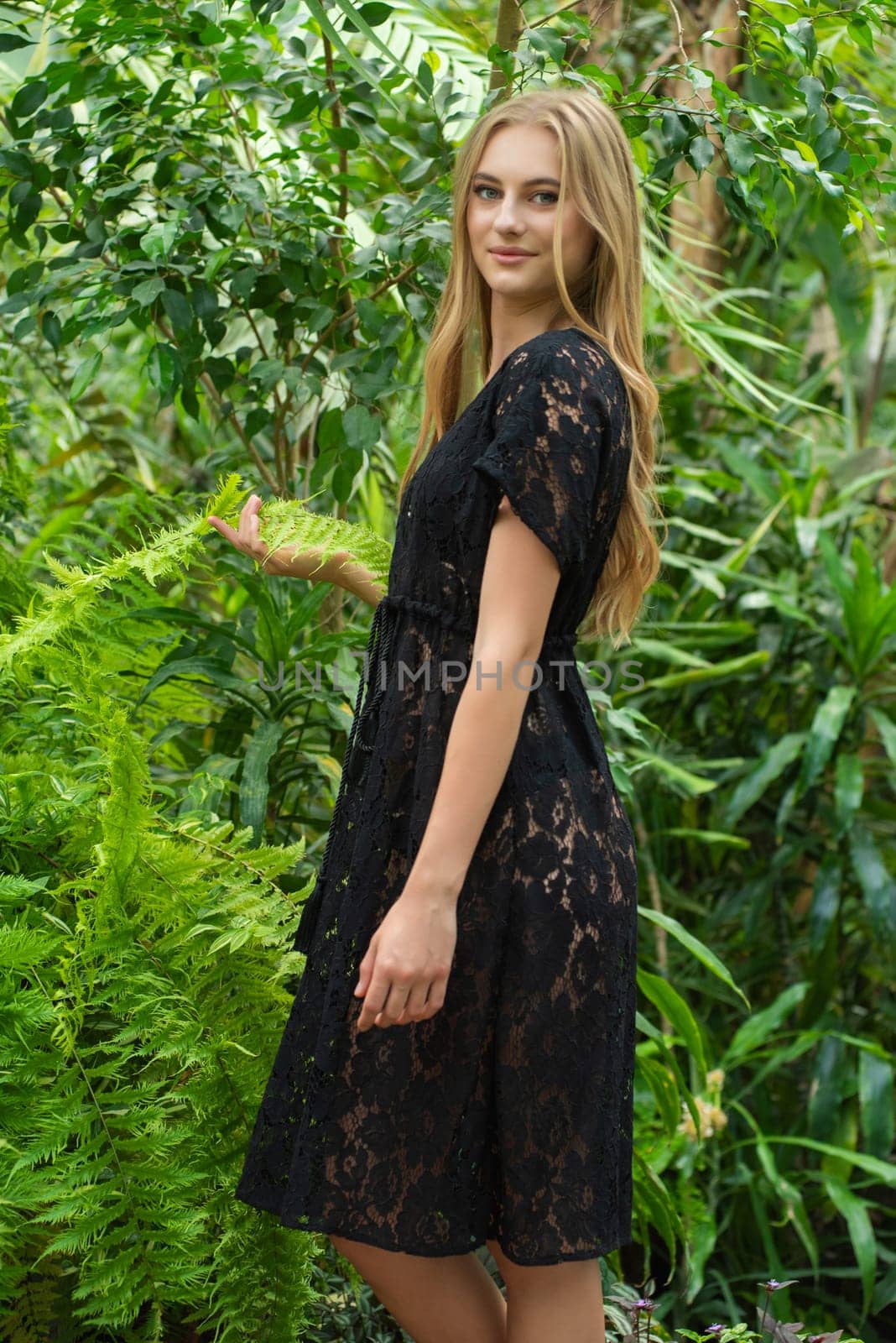 Beautiful young woman wearing summer clothes on tropical resort by OleksandrLipko