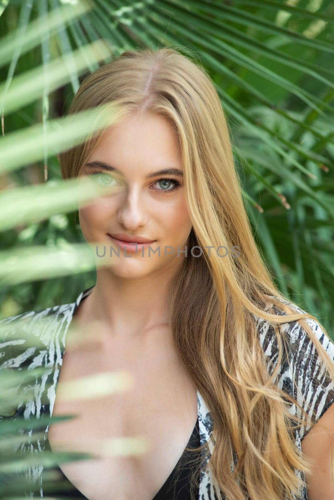 Beautiful young woman wearing summer clothes on tropical resort by OleksandrLipko