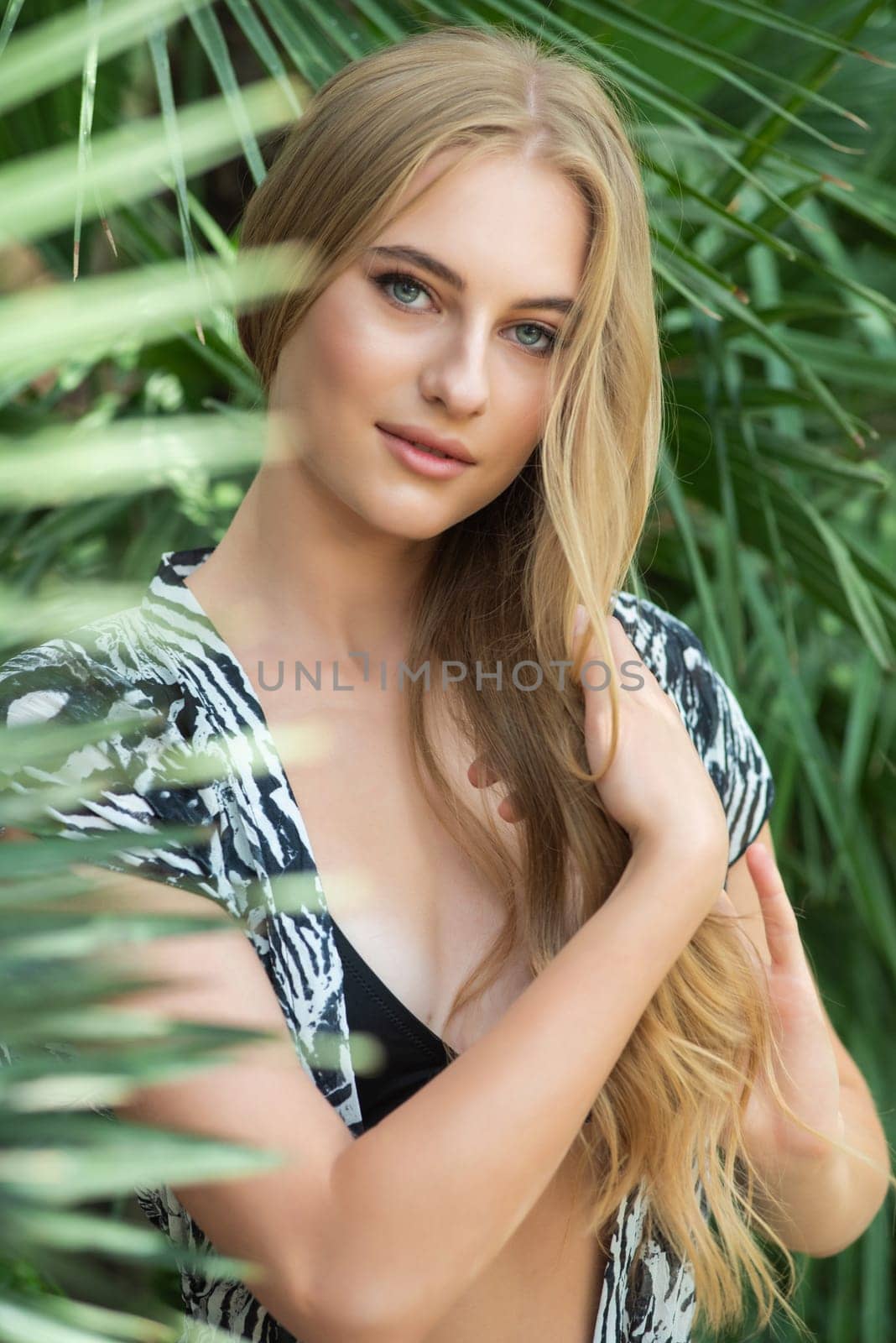 Beautiful young woman wearing summer clothes on tropical resort by OleksandrLipko