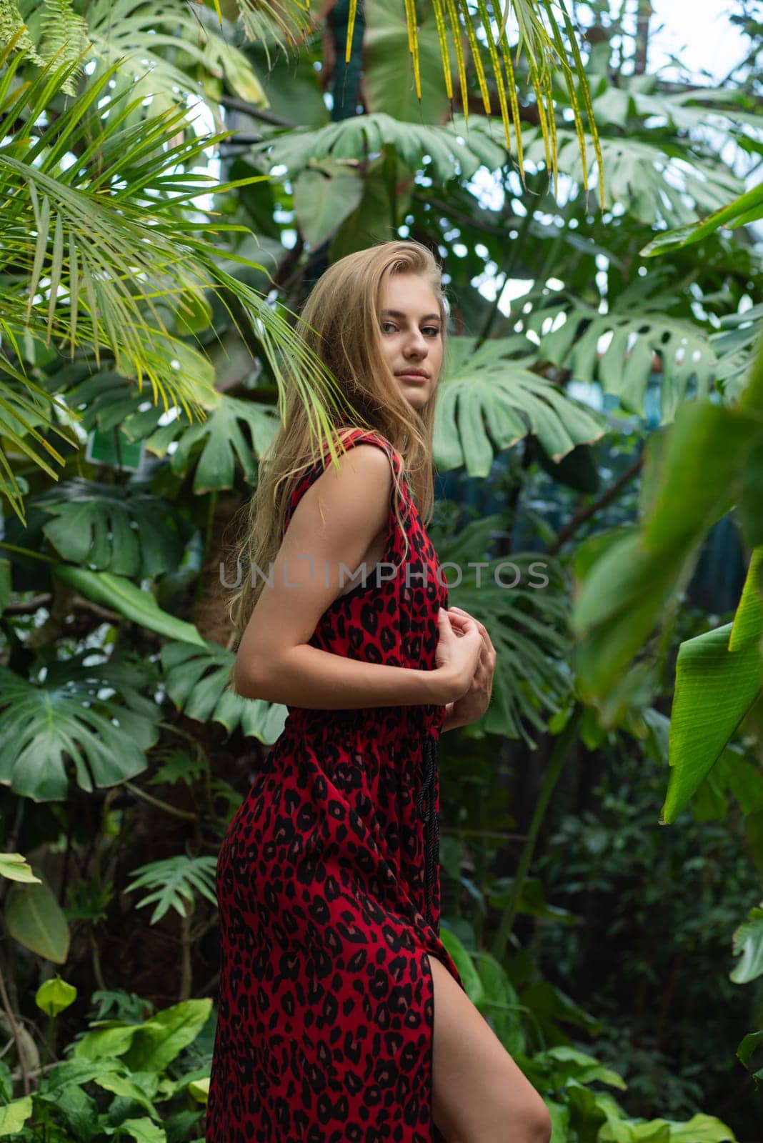 Beautiful young woman wearing summer clothes on tropical resort by OleksandrLipko