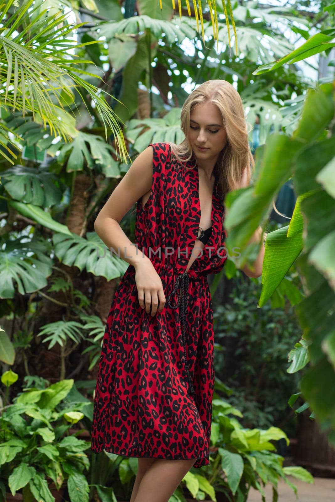 Beautiful young woman wearing summer clothes on tropical resort by OleksandrLipko