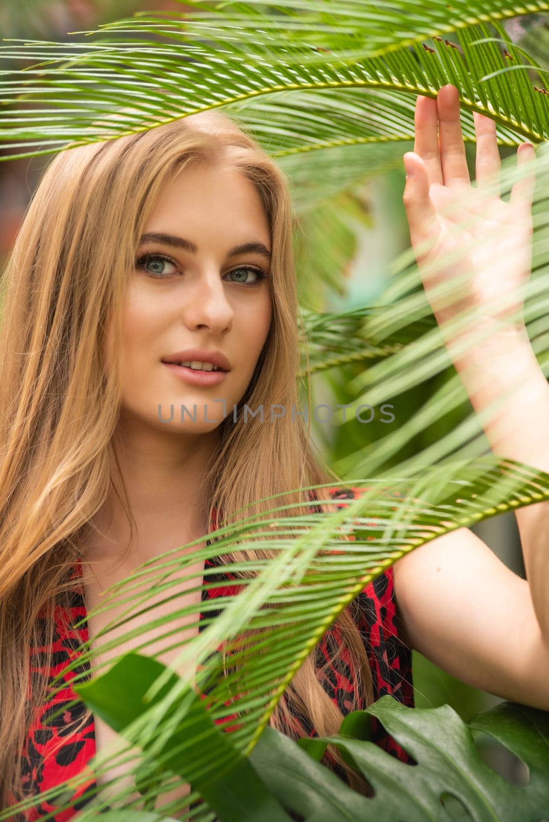 Beautiful young woman wearing summer clothes on tropical resort by OleksandrLipko