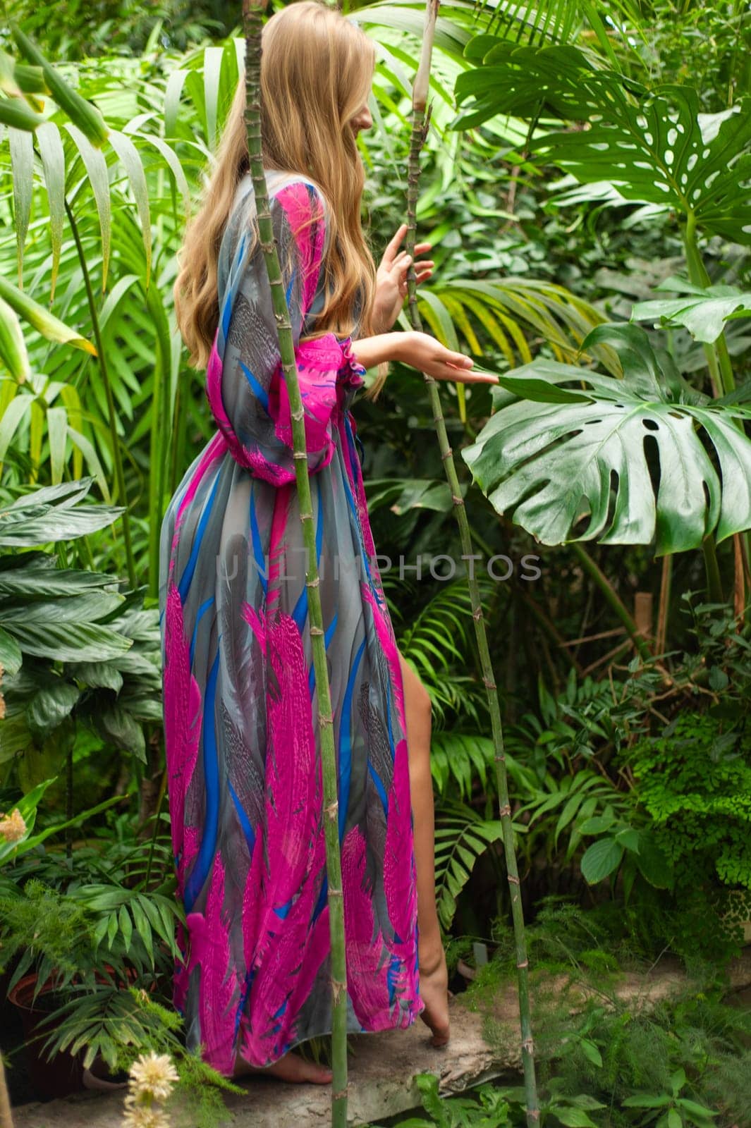 Beautiful young woman wearing summer clothes on tropical resort by OleksandrLipko