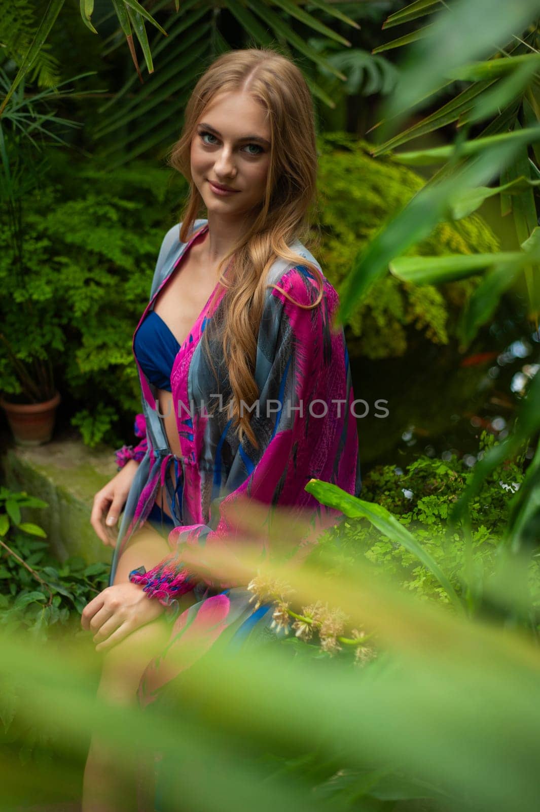 Beautiful young woman wearing summer clothes on tropical resort by OleksandrLipko