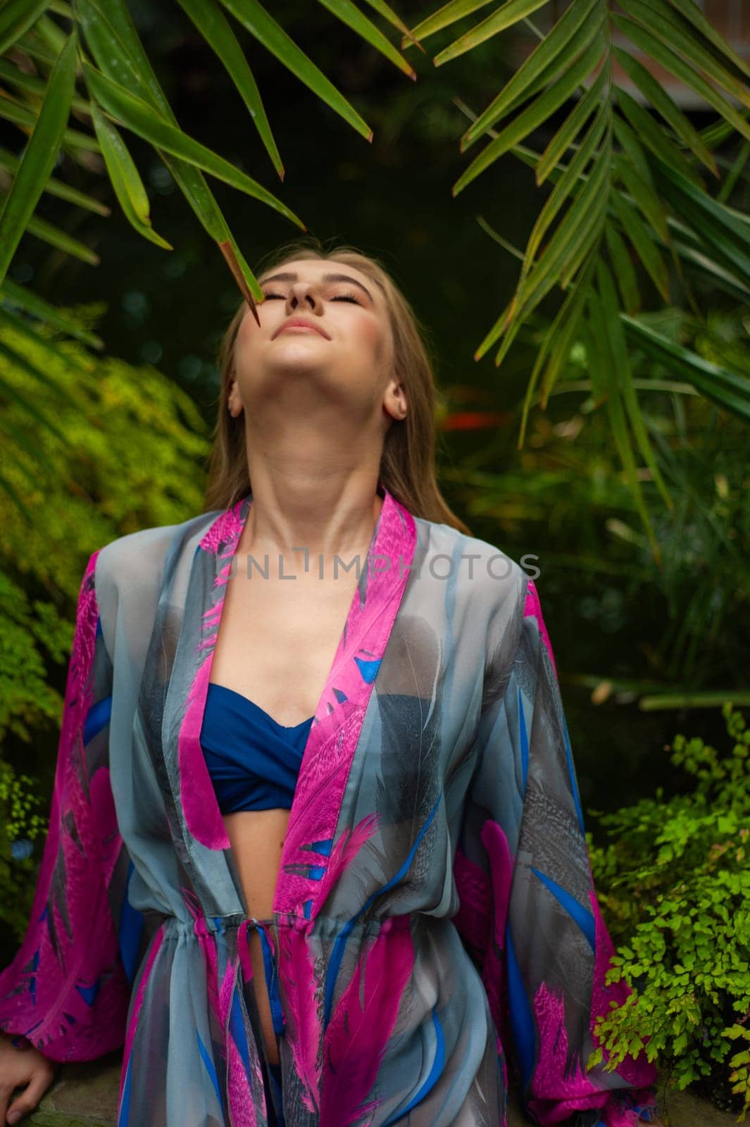 Beautiful young woman wearing summer clothes on tropical resort by OleksandrLipko