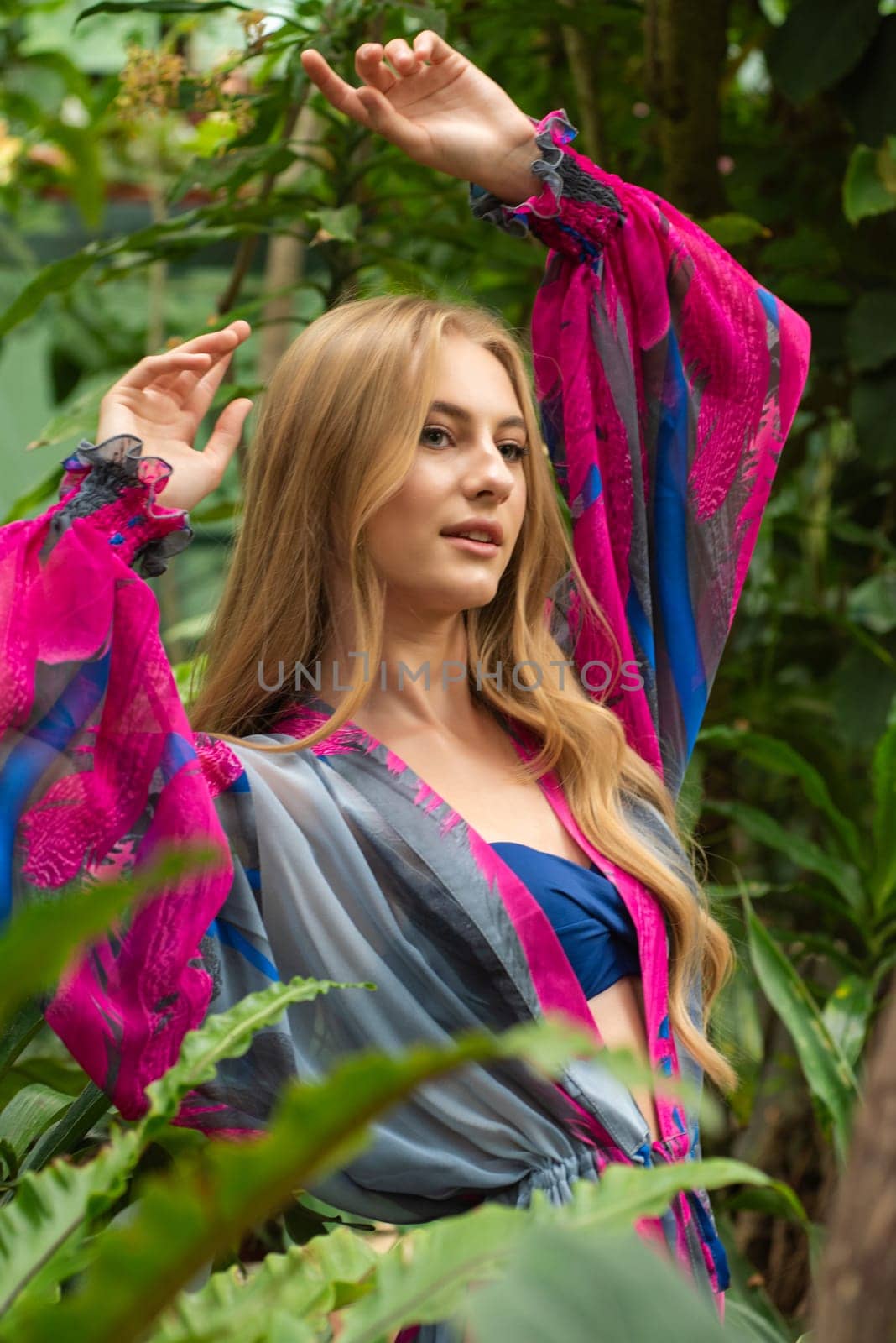 Beautiful young woman wearing summer clothes on tropical resort by OleksandrLipko