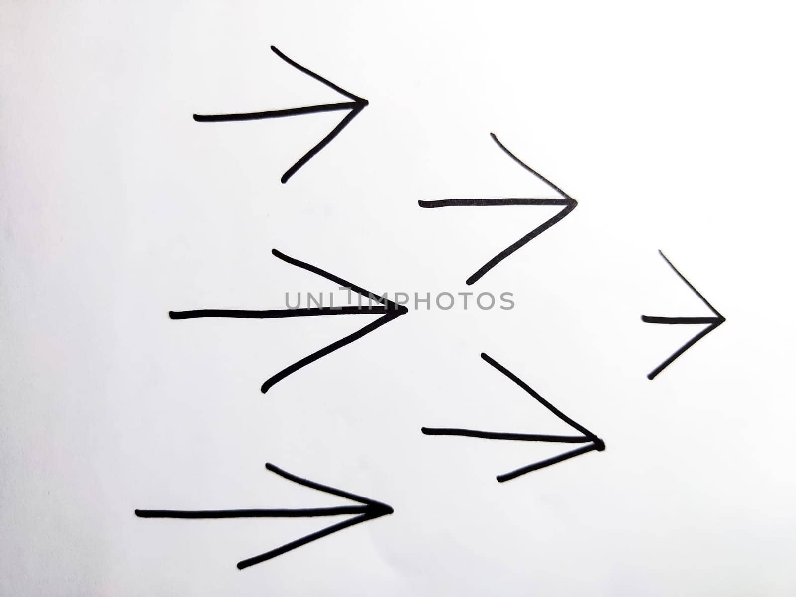 Pack drawn black marker arrows. The concept of business, choosing direction, moving forward. Abstract sign, background, texture. Partial focus, blur