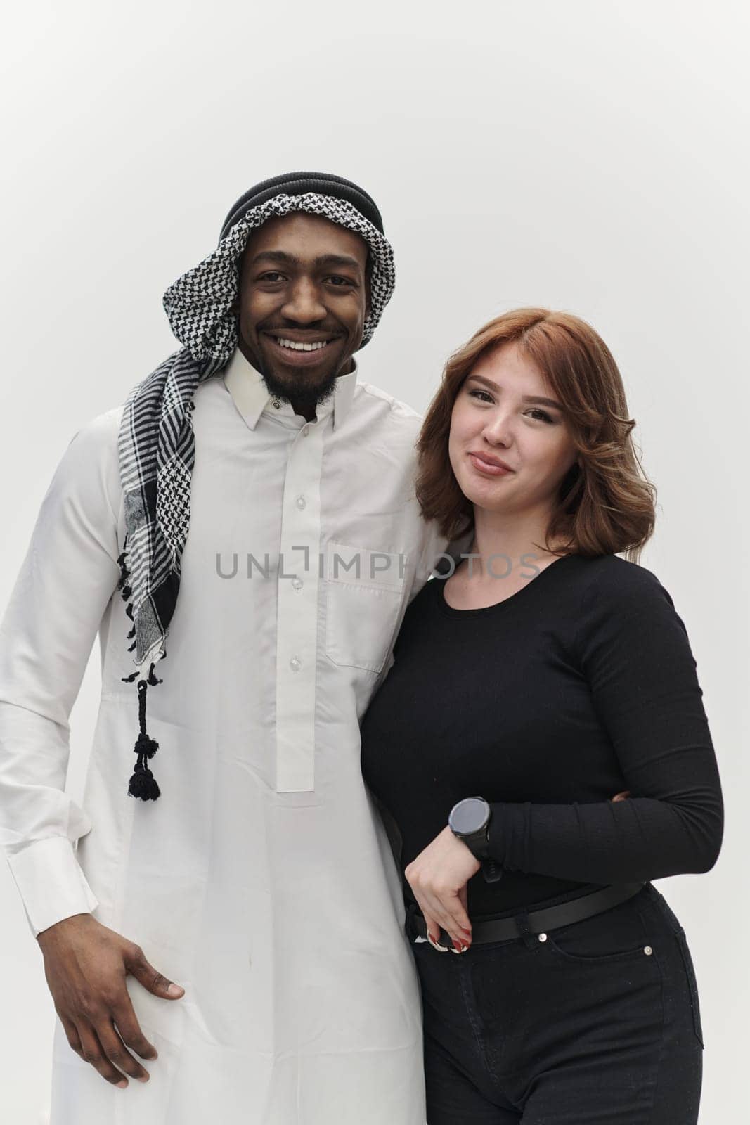 Muslim entrepreneur and a contemporary red-haired girl strike a pose together against a clean white background, embodying confidence, diversity, and a dynamic entrepreneurial spirit in their partnership by dotshock