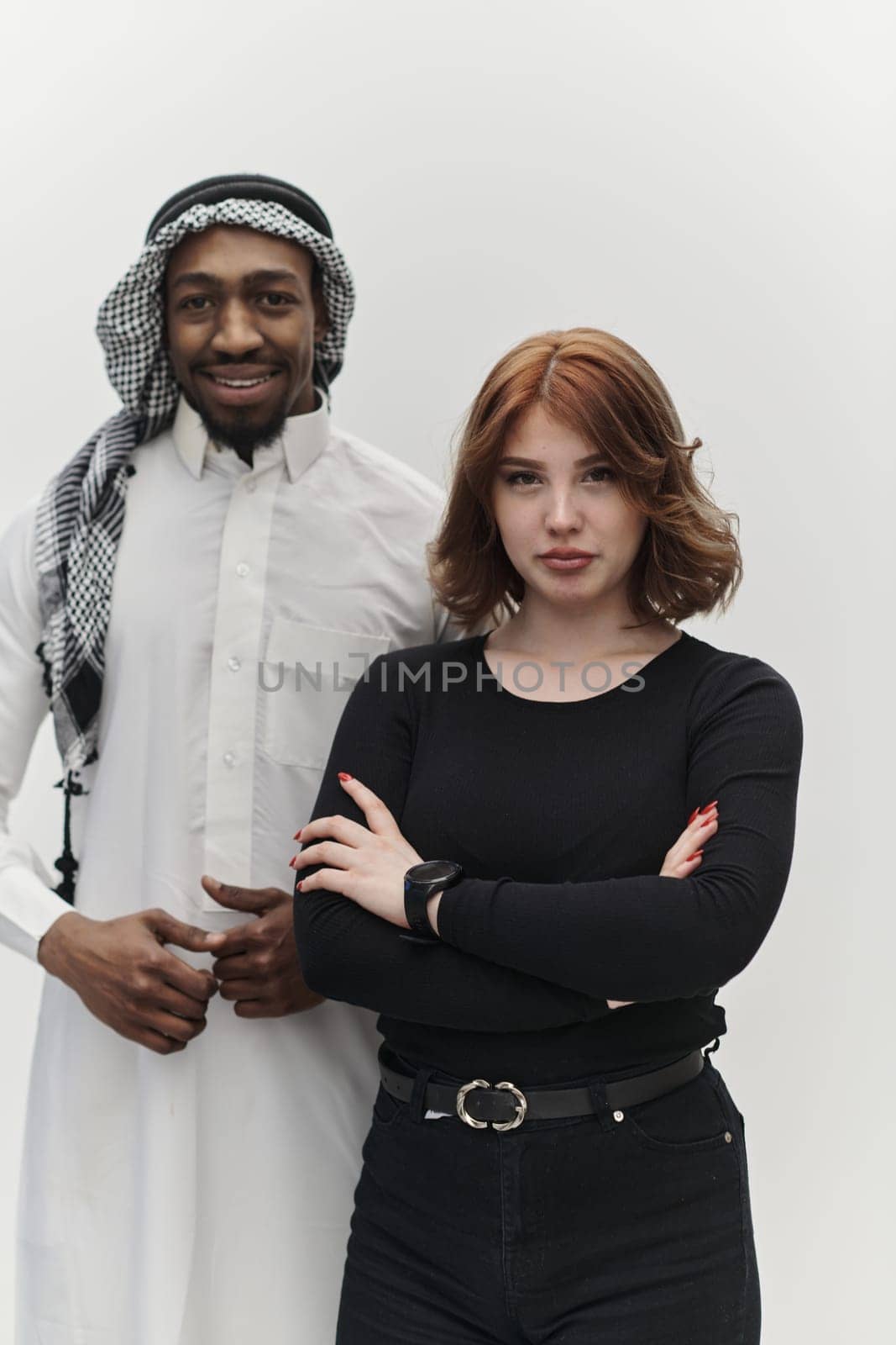 Muslim entrepreneur and a contemporary red-haired girl strike a pose together against a clean white background, embodying confidence, diversity, and a dynamic entrepreneurial spirit in their partnership by dotshock