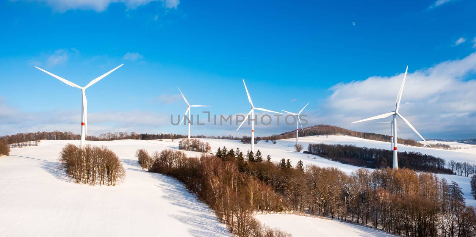 Aerial view of wind turbine farm on the hill in winter sunny day by vladimka