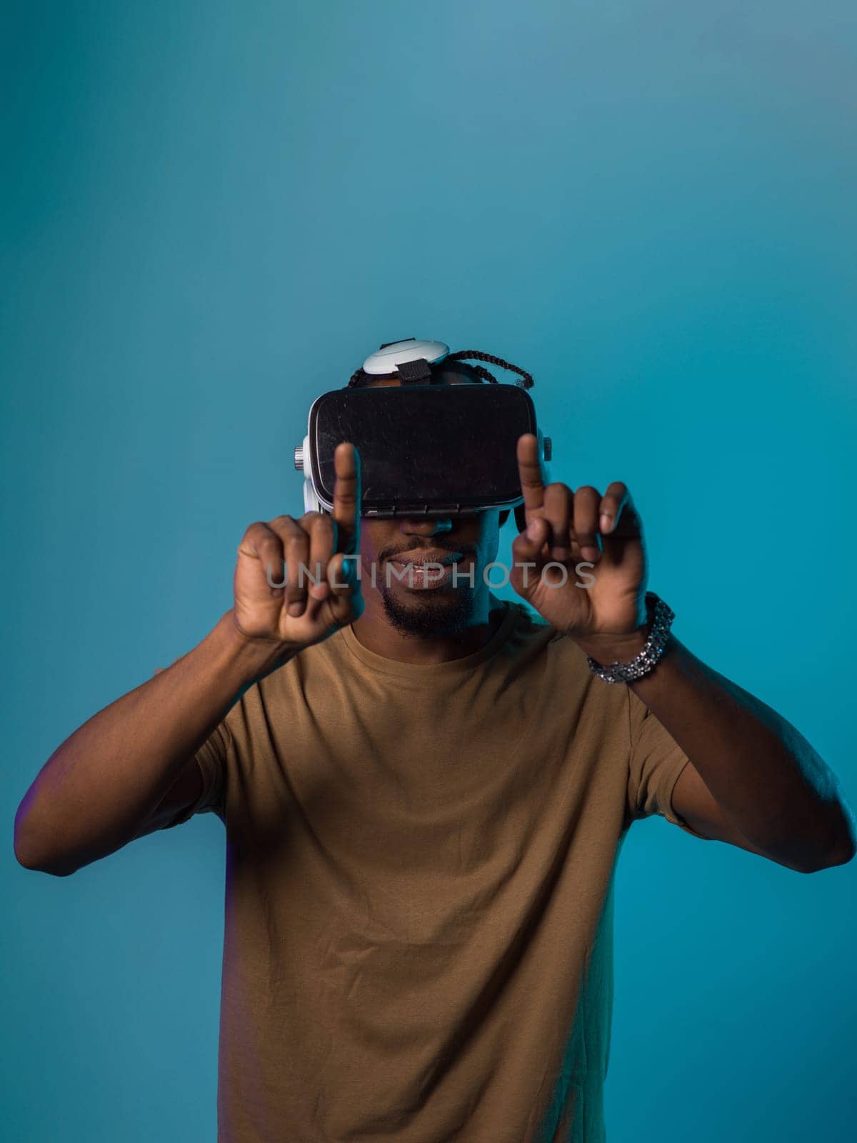 Immersed in a digital realm, an African American man navigates the virtual landscape with a VR goggles, using tactile gestures to interact with virtual objects, showcasing a harmonious blend of technology, innovation, and diverse empowerment.