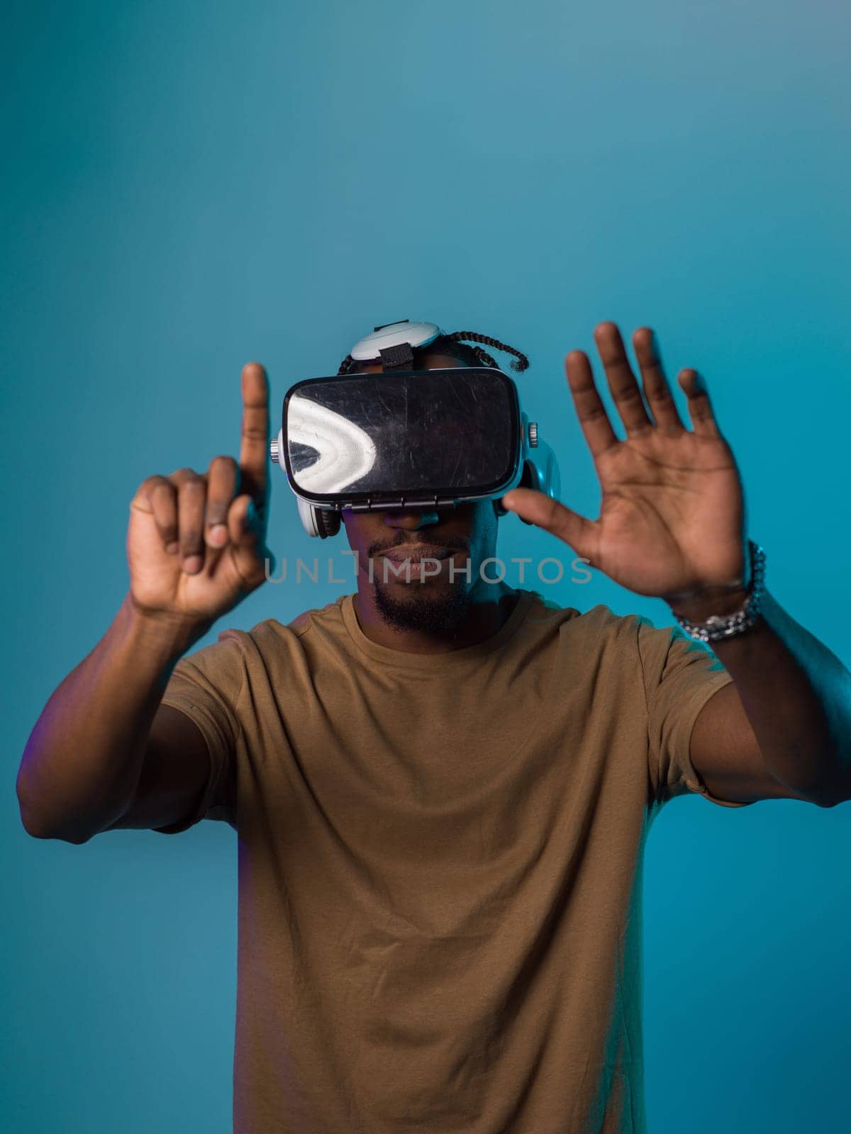 Immersed in a digital realm, an African American man navigates the virtual landscape with a VR goggles, using tactile gestures to interact with virtual objects, showcasing a harmonious blend of technology, innovation, and diverse empowerment.