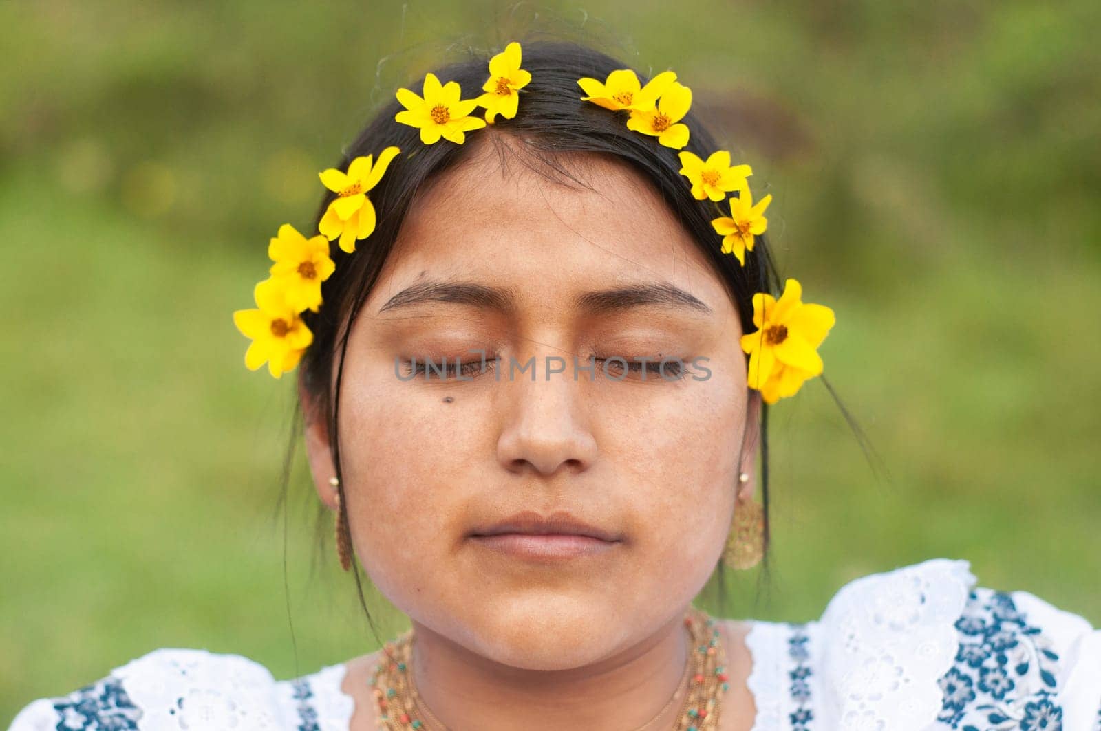 A young woman with closed eyes appears peaceful, adorned with a yellow flower headband, wearing traditional Ecuadorian clothing, embodying a moment of tranquility.