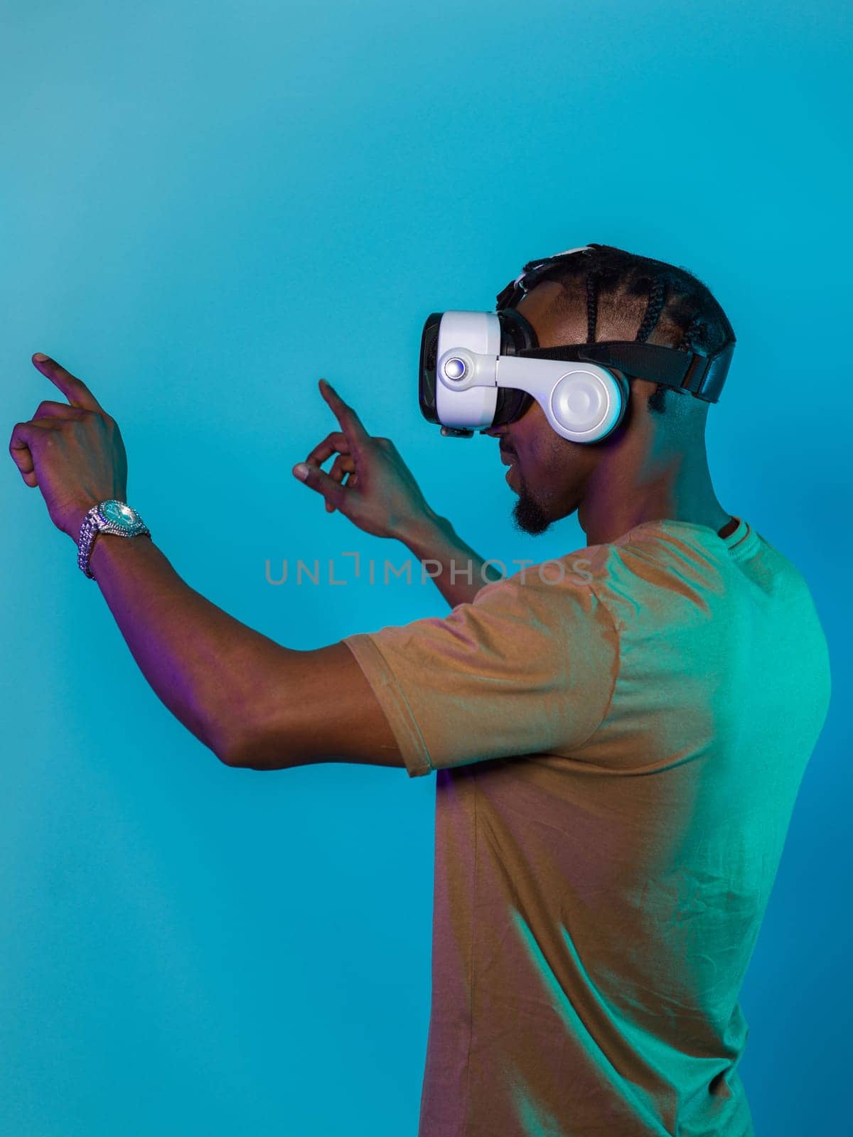 Immersed in a digital realm, an African American man navigates the virtual landscape with a VR goggles, using tactile gestures to interact with virtual objects, showcasing a harmonious blend of technology, innovation, and diverse empowerment.