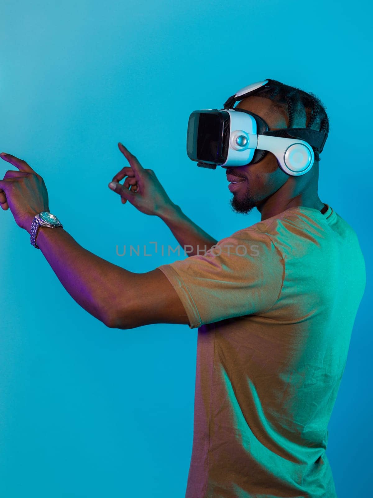 Immersed in a digital realm, an African American man navigates the virtual landscape with a VR goggles, using tactile gestures to interact with virtual objects, showcasing a harmonious blend of technology, innovation, and diverse empowerment by dotshock