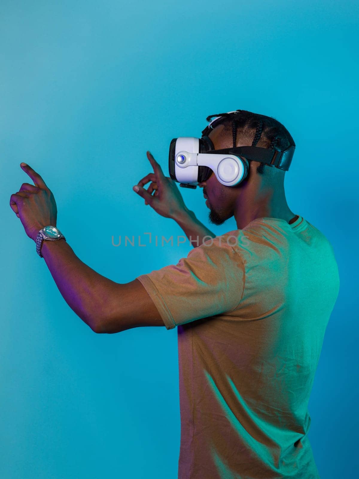 Immersed in a digital realm, an African American man navigates the virtual landscape with a VR goggles, using tactile gestures to interact with virtual objects, showcasing a harmonious blend of technology, innovation, and diverse empowerment by dotshock