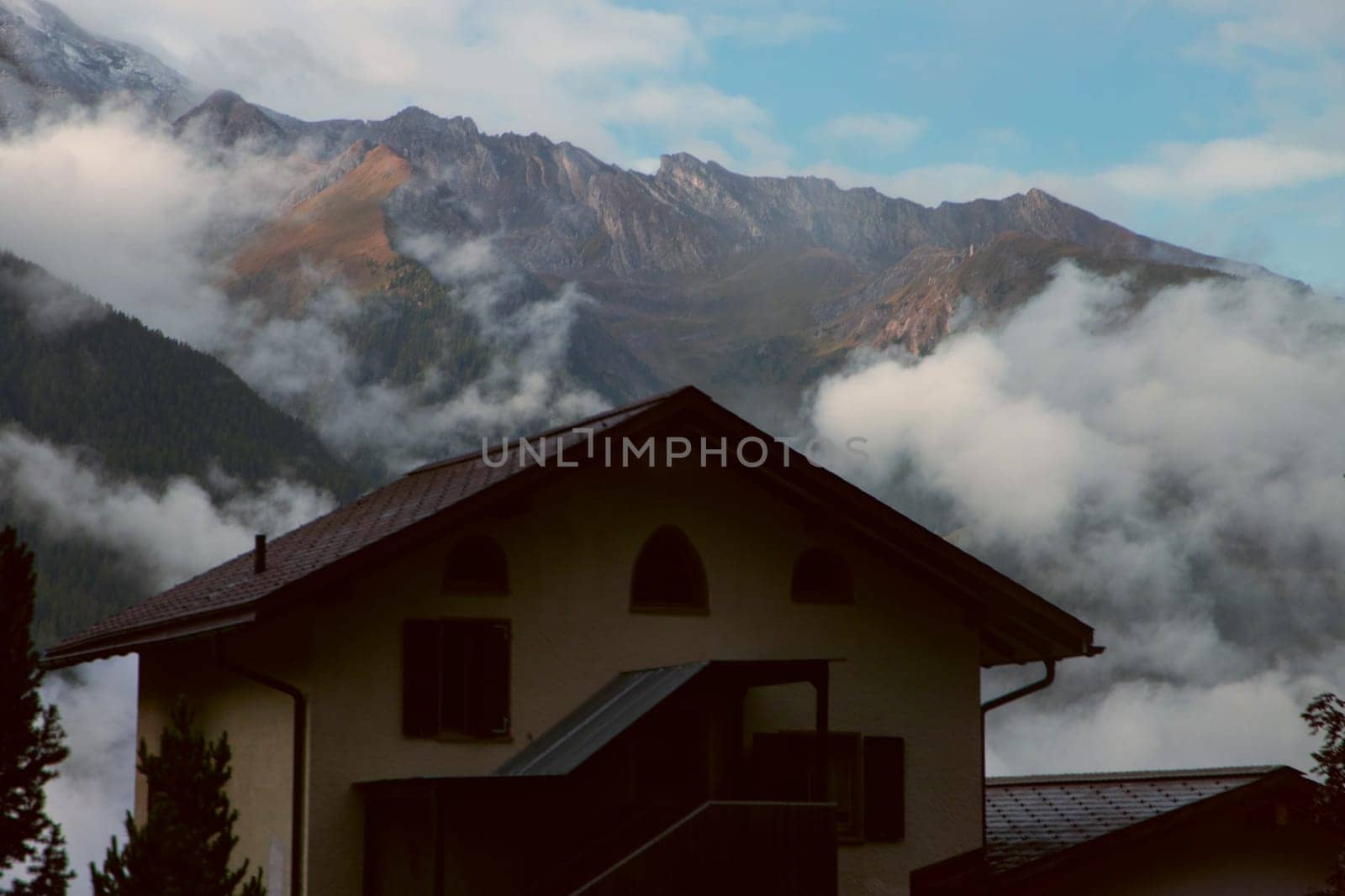 Alpine Awakening: A Home Where the Clouds and Mountains Meet. High quality photo