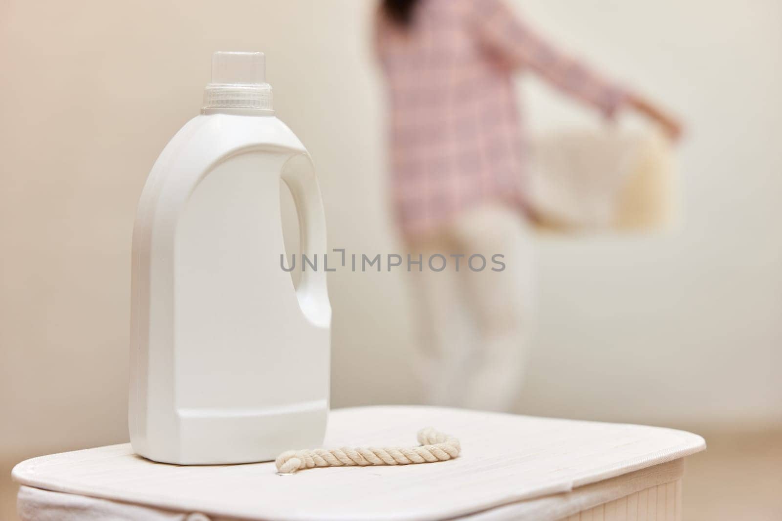 washing gel or laundry detergent on white laundry basket. Mock up, copy space.