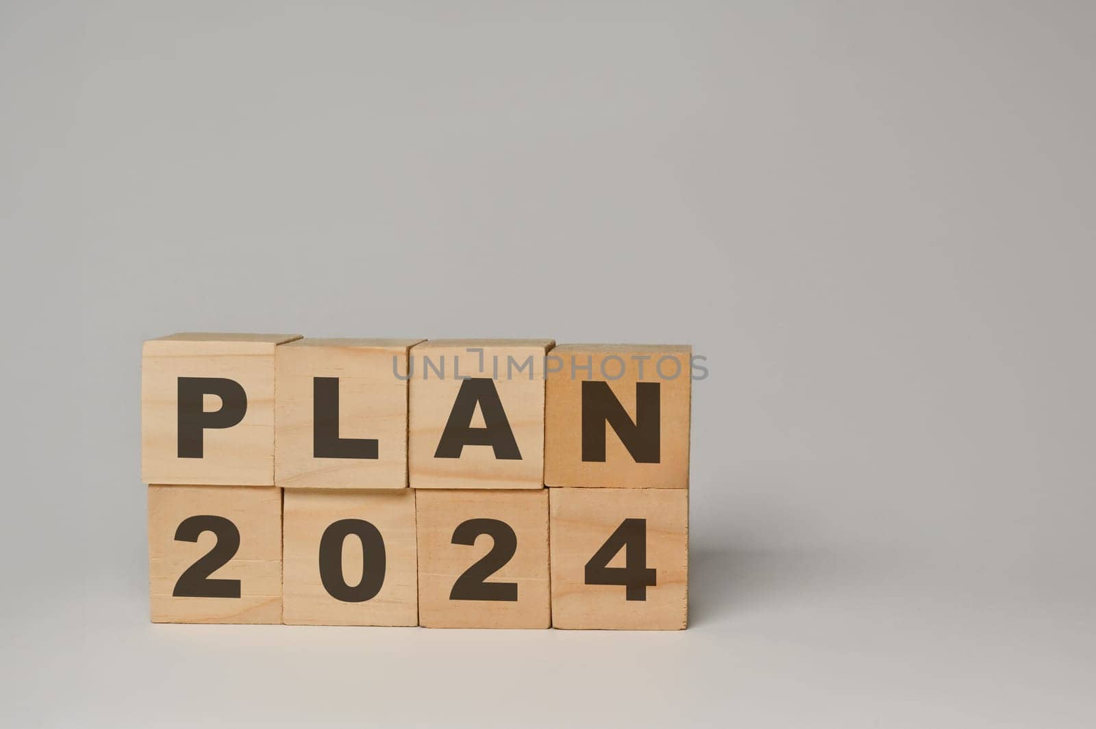 Wooden cube blocks with 2024 PLAN word on white background. Business action plan, goals and strategy concept.