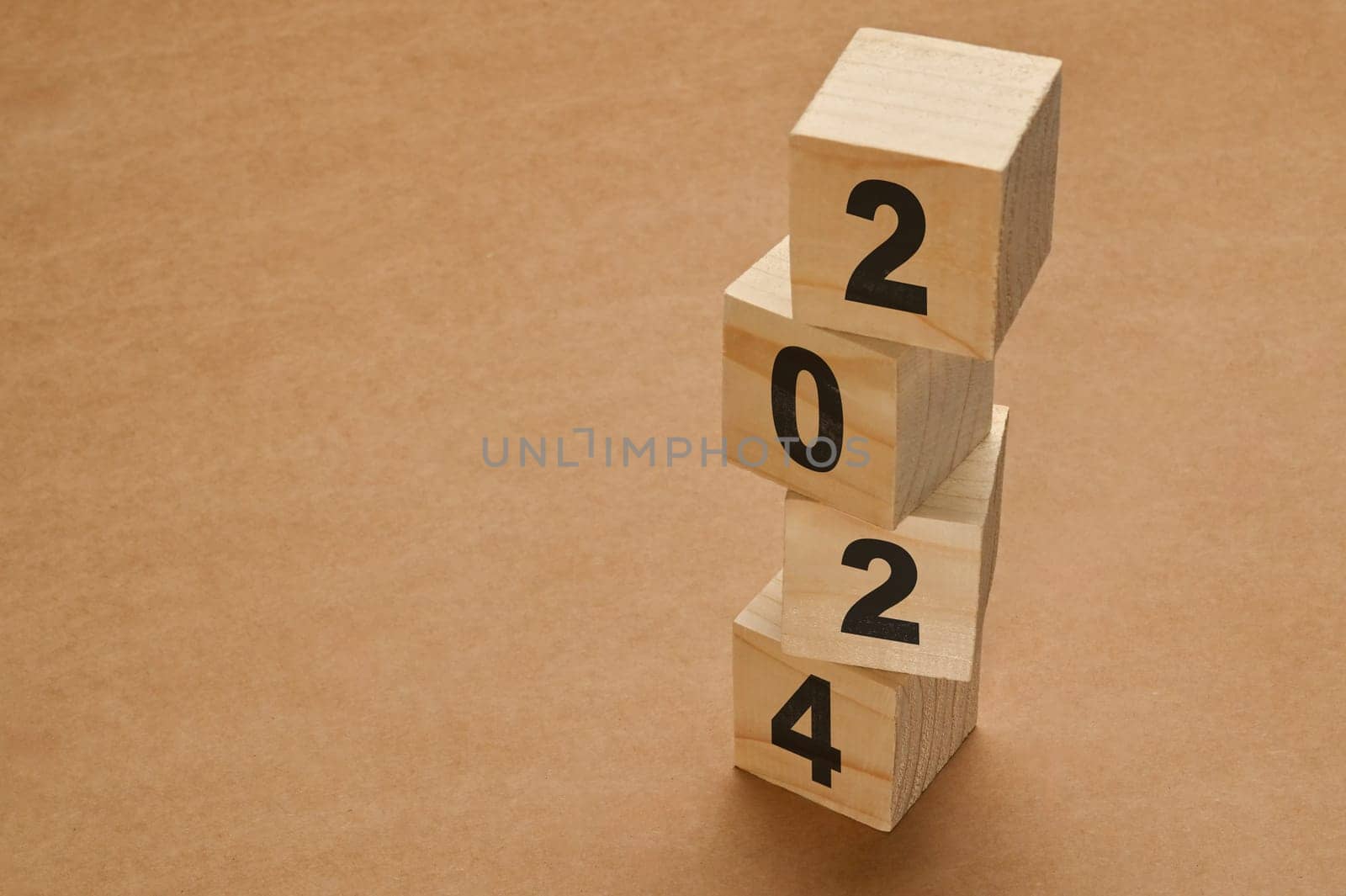 2024 numbers on wooden cube blocks stack on brown background. New Year 2024 Concept by prathanchorruangsak