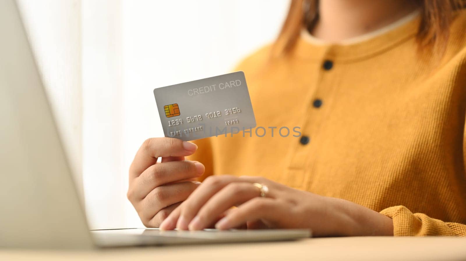 Cropped shot women using laptop and buying online with a credit card. People and technology concept by prathanchorruangsak