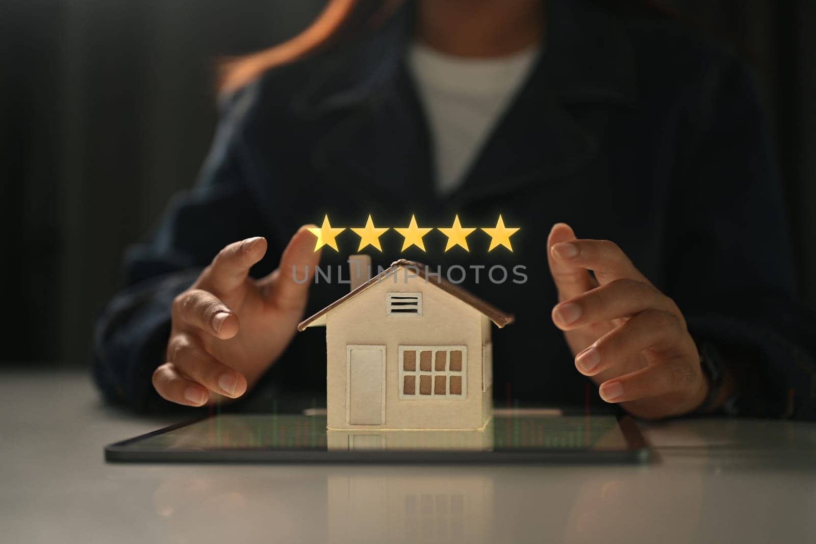 Businesswoman showing 5 stars rating with home model. Real estate appraisal concept and excellent service concept.